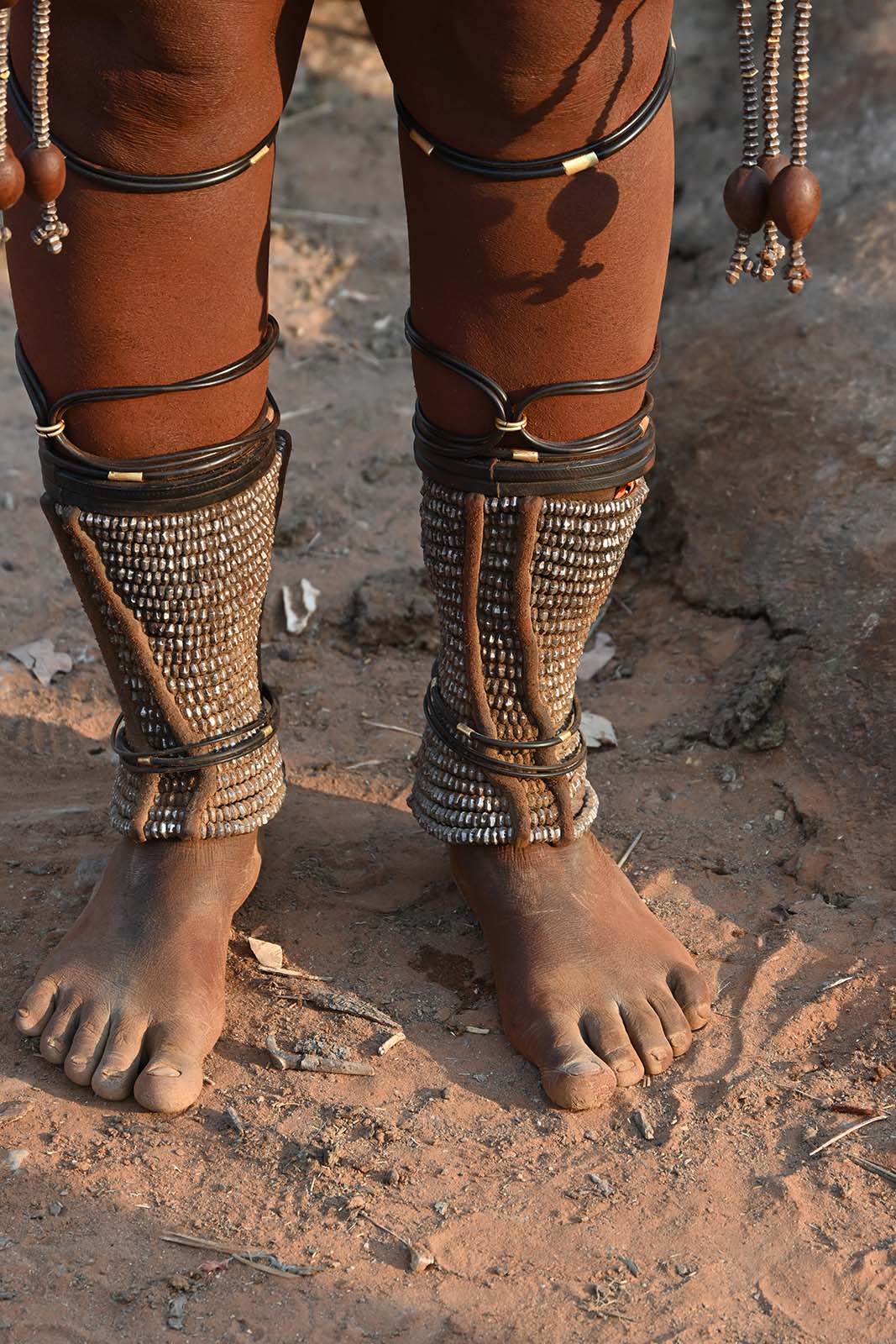 Beine einer Himba Frau mit symbolischem Fußschmuck